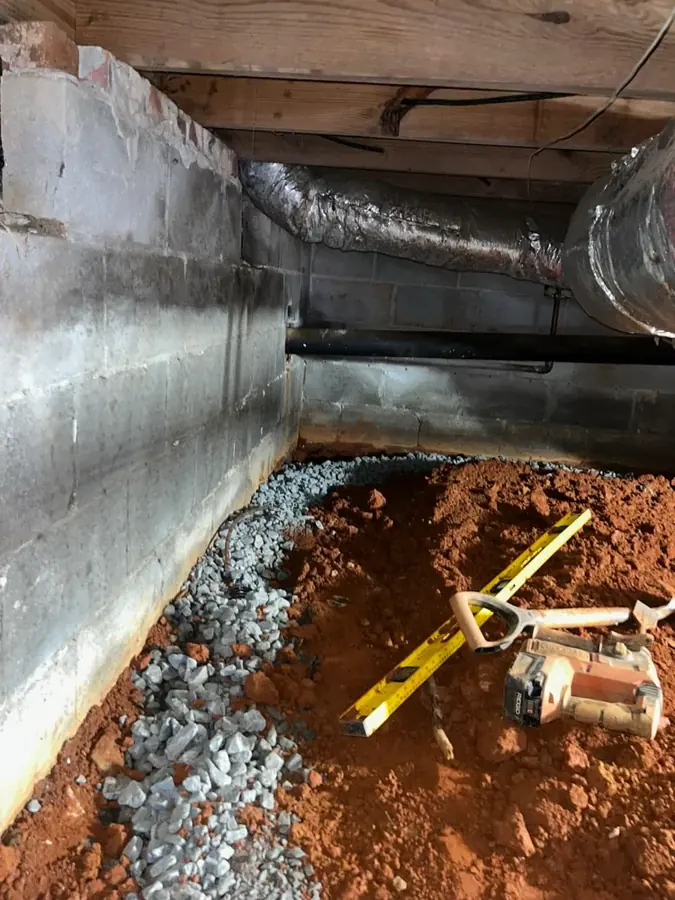Technician drying a wet crawl space under an older Atlanta home